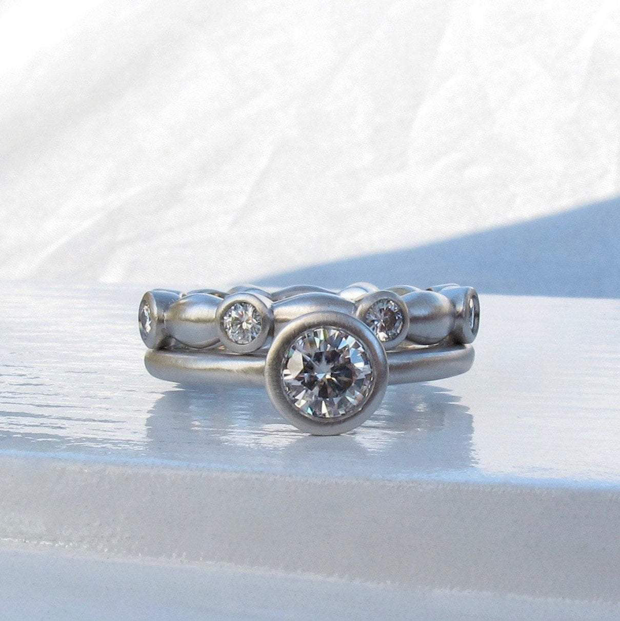 Classic bezel diamond ring with matching platinum and diamond eternity ring