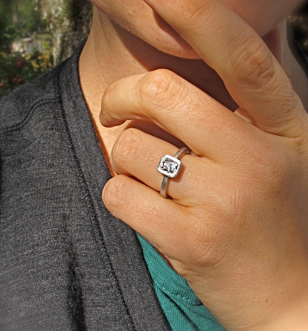 Platinum and cushion cut diamond tapered band solitaire low profile bezel set engagement ring