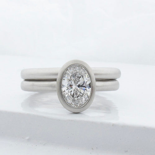 Peekaboo open bezel engagement ring semi-mount with matching rounded wedding band