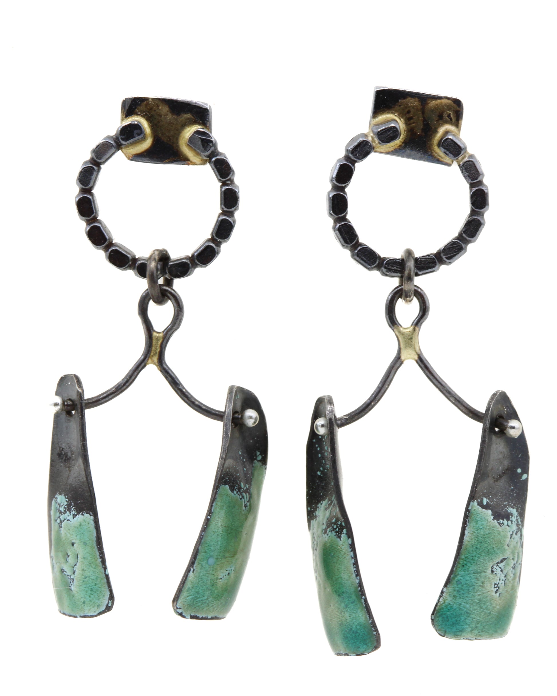 Pair of earrings with green and black design on a white background