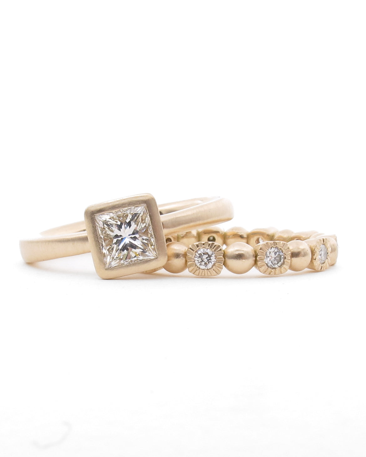 Set of pink gold rings with diamond accents on a white background