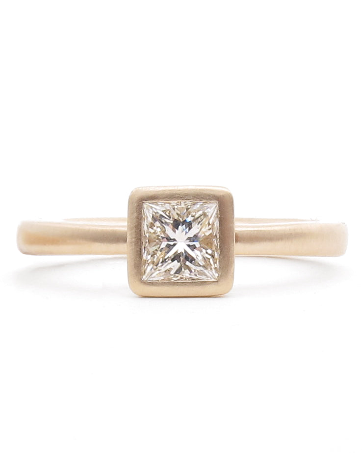 Rose gold diamond bezel ring with princess cut diamond
