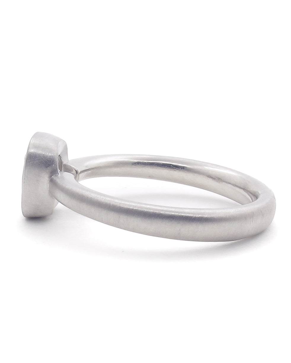 Side view of a platinum ring with bezel setting