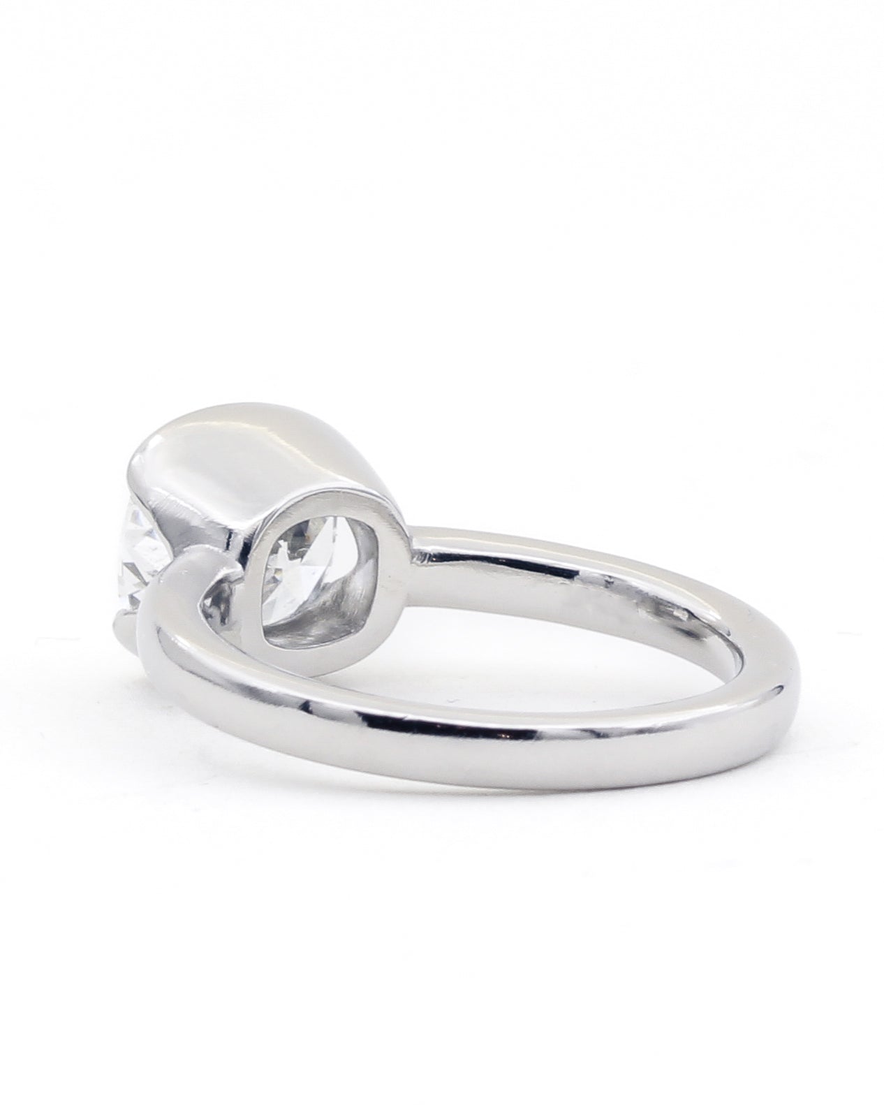 Profile view of platinum diamond bezel ring with narrow band