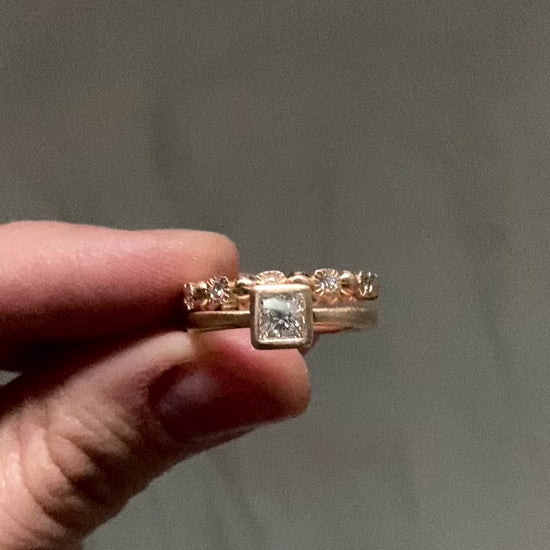 Princess diamond engagment ring stacked with a rose gold eternity band