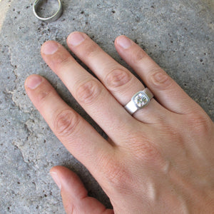Wide band cushion cut bezel set engagement ring
