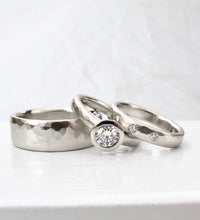 Load image into Gallery viewer, Hammer textured platinum and diamond solitaire with matching diamond wedding band