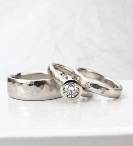 Hammer textured platinum and diamond solitaire with matching diamond wedding band
