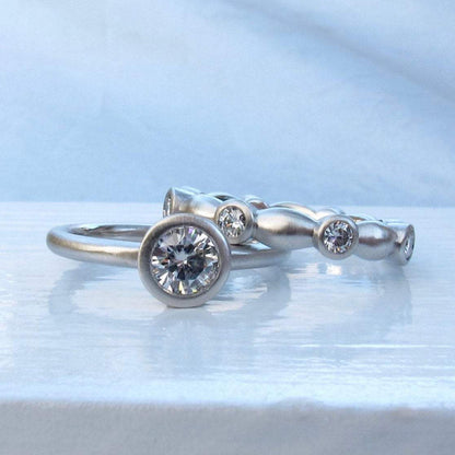Classic bezel diamond ring with matching platinum and diamond eternity ring