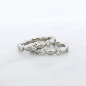 Minimalist wedding band and engagement ring set, low profile bezel set solitaire with stacking bezel set eternity ring