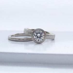 Bezel set solitaire lab grown diamond engagement ring with narrow hammered wedding band