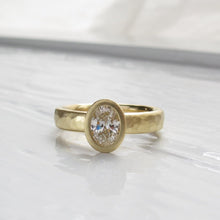 Load image into Gallery viewer, Oval diamond bezel set engagement ring with rustic hammered texture