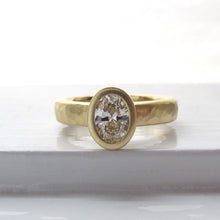 Load image into Gallery viewer, Oval diamond bezel set engagement ring with rustic hammered texture